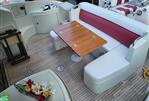 Azimut 43S - Luxury seating area on 2009 Azimut 43S yacht with wooden table and floral arrangement.