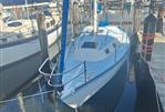 Lancer Yachts 30 Sloop - 1979 Lancer Yachts 30 Sloop docked in a marina, clear sky reflection.