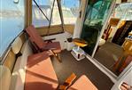 Beneteau Antares 760 - Interior of 2002 Beneteau Antares 760 boat with seating and table.