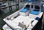 Bertram Flybridge Cruiser - Dockside With Cushions Out On Engine Boxes