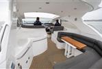 Sunseeker Portofino 47 - 2009 Sunseeker Portofino 47 yacht interior with seating and helm, cruising on open water.