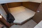 Jeanneau Leader 33 - 2021 Jeanneau Leader 33 cabin interior with beige cushions and wooden accents.