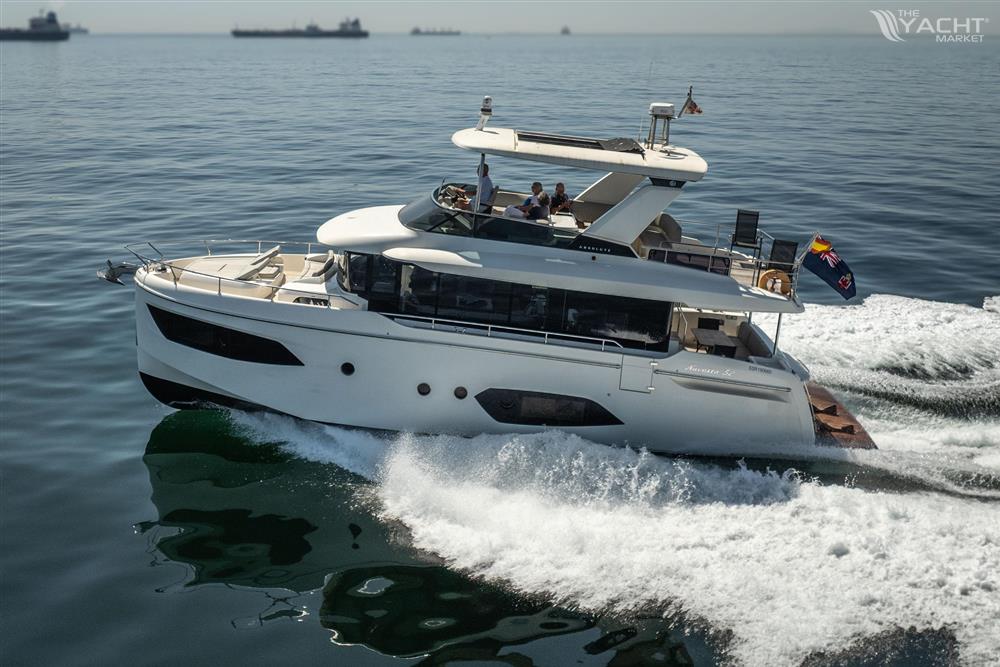Absolute 52 Navetta - Luxury yacht Absolute 52 Navetta 2021 cruising on open sea, creating waves.