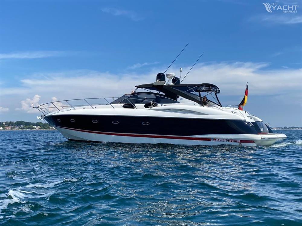 Sunseeker Camargue 50 - 2001 Sunseeker Camargue 50 yacht cruising on open water under a clear blue sky.
