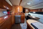 Sunseeker Camargue 50 - Luxurious interior of 2001 Sunseeker Camargue 50 yacht with wood finishes and seating area.