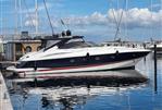 Sunseeker Camargue 50 - 2001 Sunseeker Camargue 50 yacht docked in a marina under a blue sky.