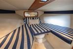 Chris-Craft Corsair 28 Heritage Edition - 2013 Chris-Craft Corsair 28 Heritage Edition cabin with striped bedding and compact design.