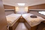 Princess V48 Open - Luxurious cabin interior of 2017 Princess V48 Open yacht with twin beds and modern decor.