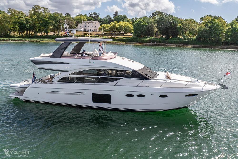 Princess 60 - Luxurious 2015 Princess 60 yacht cruising on a serene river with lush greenery.
