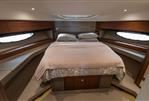 Princess 60 - Luxurious cabin interior of 2015 Princess 60 yacht with elegant bedding and wood accents.