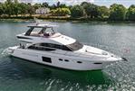 Princess 60 - Luxurious 2015 Princess 60 yacht cruising on a serene river with lush greenery.