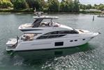 Princess 60 - Luxury 2015 Princess 60 yacht cruising on a serene waterway, surrounded by lush greenery.