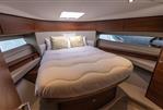 Princess F50 - Luxurious 2019 Princess F50 yacht bedroom with elegant wood finishes and cozy bedding.