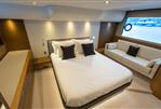 Princess 56 - Luxurious bedroom interior of 2014 Princess 56 yacht with elegant furnishings and large window view.