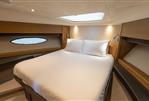 Princess 56 - Luxurious cabin interior of 2014 Princess 56 yacht with cozy bed and ambient lighting.