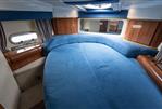 Sealine S34 - Luxurious 2004 Sealine S34 yacht interior with blue upholstery and wooden accents.