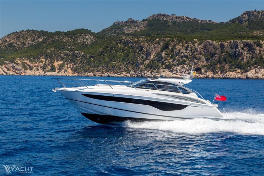 Princess V40 - 2019 Princess V40 yacht cruising on blue ocean near rocky coastline.