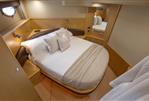 Princess V58 - Luxurious cabin interior of 2009 Princess V58 yacht with cozy bed and elegant decor.