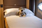 Princess V58 - Plush toy on bed inside 2009 Princess V58 yacht cabin.
