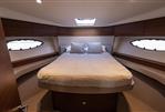 Princess 49 - Luxurious bedroom interior of 2017 Princess 49 yacht with elegant wood finishes.