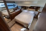 Princess F50 - Luxurious bedroom interior of 2023 Princess F50 yacht with elegant wood finishes and modern design.