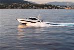 Galeon 405 HTS - 2023 Galeon 405 HTS yacht cruising on serene waters at sunset.