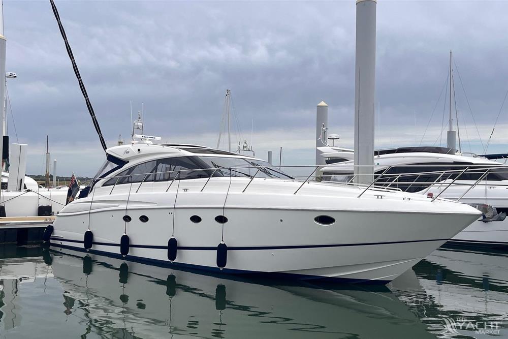 Princess V53 - Luxury 2006 Princess V53 yacht docked at marina under cloudy sky.