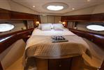 Princess 54 - Luxurious cabin interior of 2009 Princess 54 yacht with elegant bedding and porthole windows.