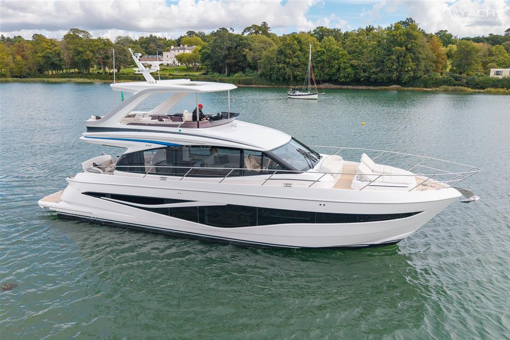 Princess F58 - 2025 Princess F58 yacht on serene water with lush green shoreline.