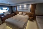 Princess 68 - Luxurious bedroom interior on a 2015 Princess 68 yacht, featuring elegant wood finishes.