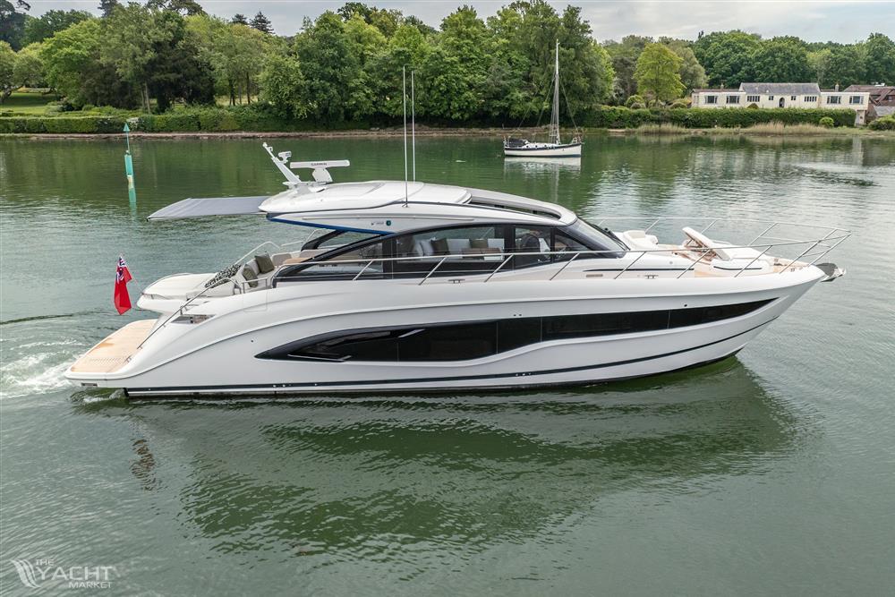 Princess V55 - 2025 Princess V55 yacht cruising on a serene lake with lush greenery.