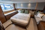 Princess V55 - Luxurious cabin interior of 2025 Princess V55 yacht with elegant bedding and seating.