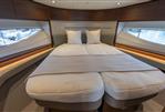 Princess V55 - Luxurious interior of 2025 Princess V55 yacht with elegant bedding and panoramic windows.