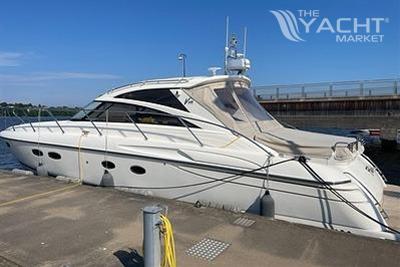 Princess V48 - 2007 Princess V48 yacht docked at a marina under clear blue skies.