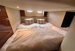 Princess V48 - Luxurious cabin interior of 2007 Princess V48 yacht with cozy bedding and ambient lighting.