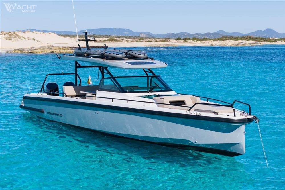 Axopar 37 Sun Top - 2024 Axopar 37 SunTop boat anchored in clear turquoise water near sandy beach.