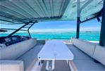Axopar 37 Sun Top - 2024 Axopar 37 SunTop boat interior with ocean view, featuring sleek seating and modern design.