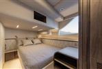 Galeon 430 Explorer - Luxurious cabin interior of 2025 Galeon 430 Explorer yacht with cozy bed and scenic window view.