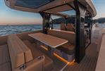Saxdor 400 GTS - Luxurious interior of 2025 Saxdor 400 GTS yacht at sunset, featuring elegant seating and table.