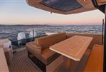 Saxdor 400 GTS - Luxury Saxdor 400 GTS boat interior with seating and table, ocean view at sunset.