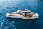 Saxdor 400 GTS - 2025 Saxdor 400 GTS luxury boat cruising on clear blue water.
