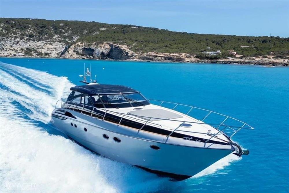 Princess V58 - 2005 Princess V58 yacht cruising in clear blue waters near rocky coastline.