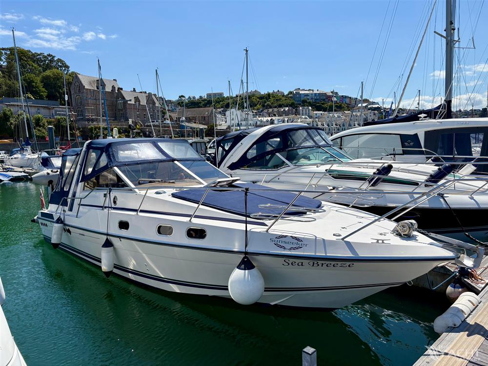 Sunseeker Offshore 31 - 1985 Sunseeker Offshore 31 yacht docked in a marina under clear blue skies.