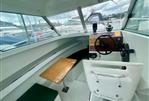 Jeanneau Merry Fisher 610 HB - Interior of 1997 Jeanneau Merry Fisher 610 HB boat with helm and seating area.