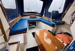 Maritime 21 - Interior of a 1992 Maritime 21 boat with blue seating and wooden table.