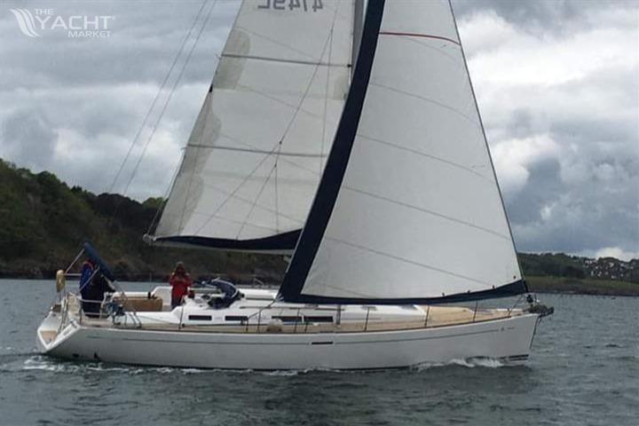 Dufour 455 Grand Large - Sailing yacht Dufour 455 Grand Large 2006 on calm waters under cloudy skies.