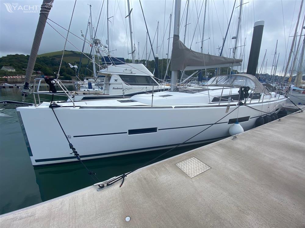 Dufour 410 - 2014 Dufour 410 sailboat docked in a marina, surrounded by other boats.