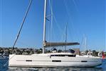 Dufour 410 - 2014 Dufour 410 sailboat on calm water under clear blue sky.
