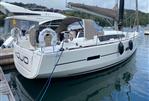 Dufour 410 - 2014 Dufour 410 sailboat docked in a marina, featuring sleek design and modern amenities.