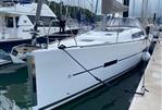 Dufour 410 - 2014 Dufour 410 sailboat docked at marina, sleek white design, ready for sailing adventure.